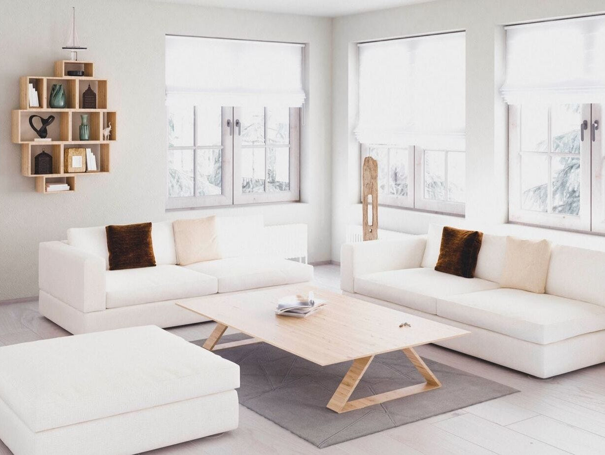 Tastefully decorated living room with a white couch, loveseat and ottoman.
