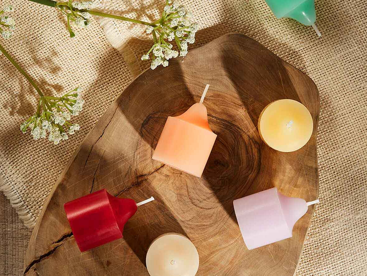 An assortment of votives both standing up and on their side.