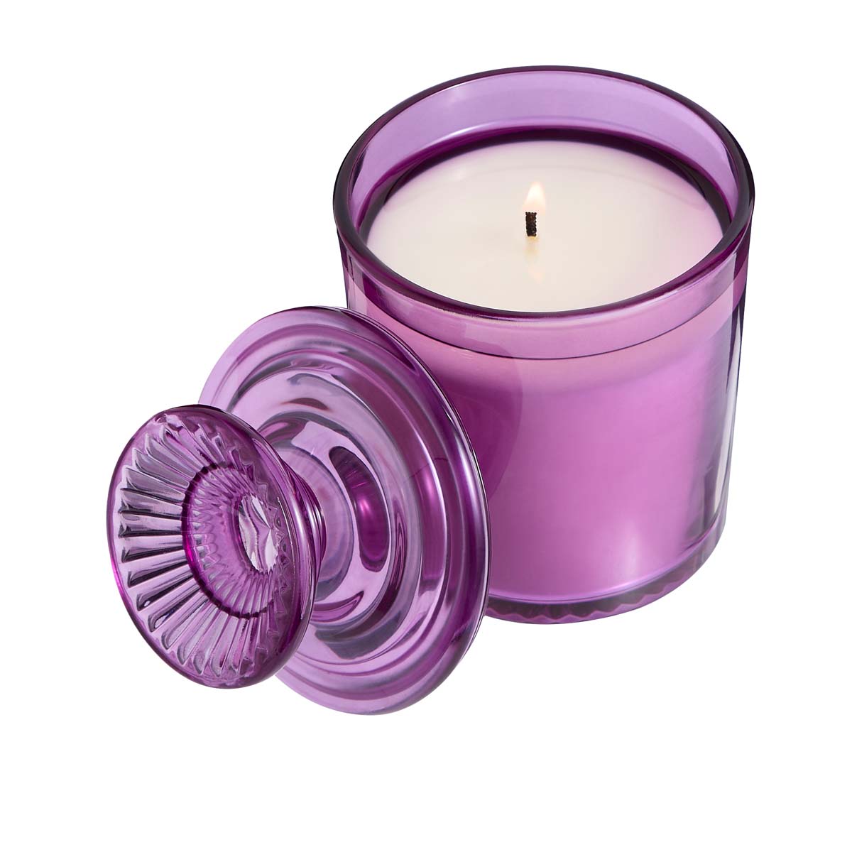 Wildflower Walk Specialty Jar Candle shown lit with the lid against it on a white white background.