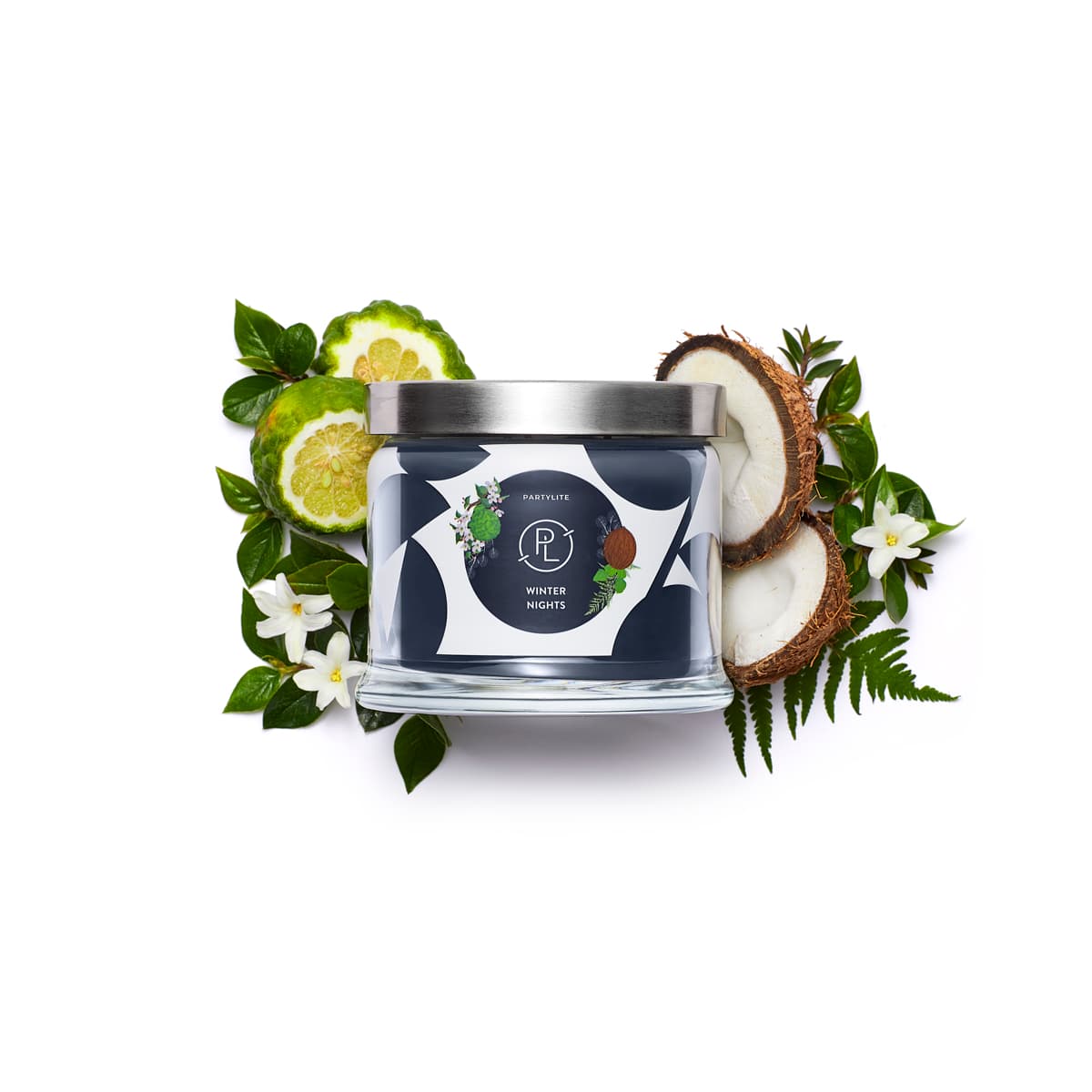 Winter Nights 3-wick Jar surrounded by sliced Limes and Coconut with leaves against a white background.