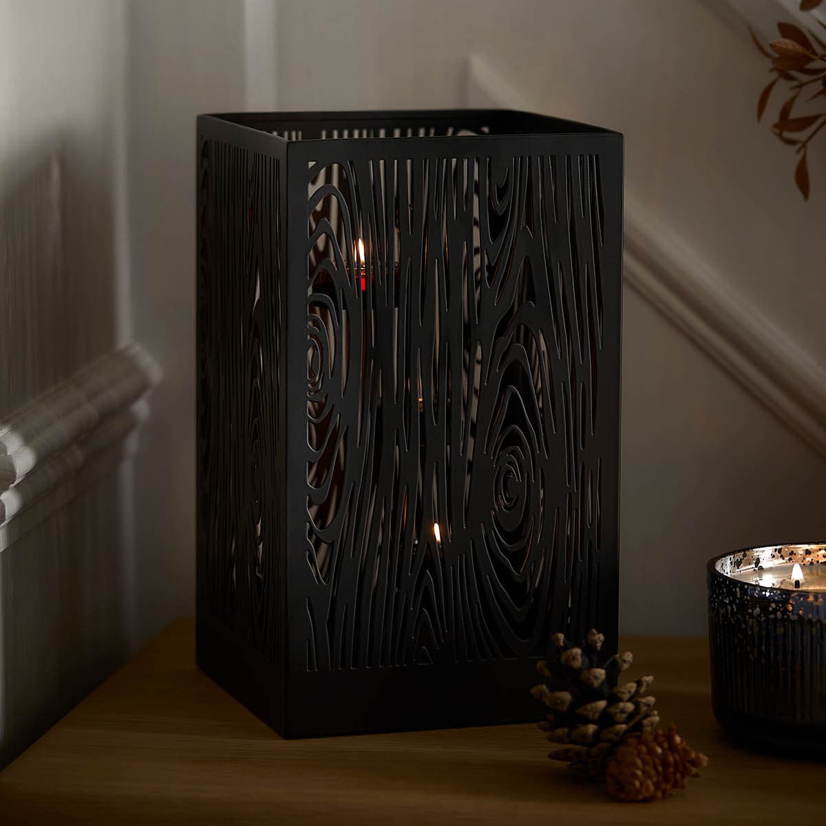 Wood Grain Hurricane light a white background on a wooden top.