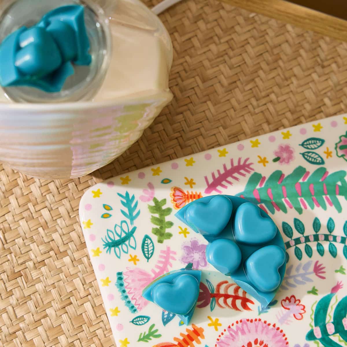 Salty Seascape Heart shaped wax melts shown on a decorative table mat with a PartyLite scent glow warmer in the background