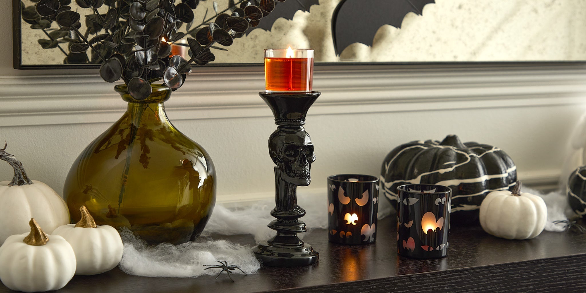 Halloween table display with skull candle holder and spooky eyes candle holder
