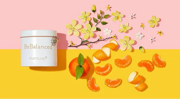 BeBalanced Jar candle on a two toned background with its fragrance notes depicted beside it. 