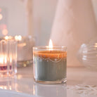 Winter Morning Mini Jar Candle lit against a light background.